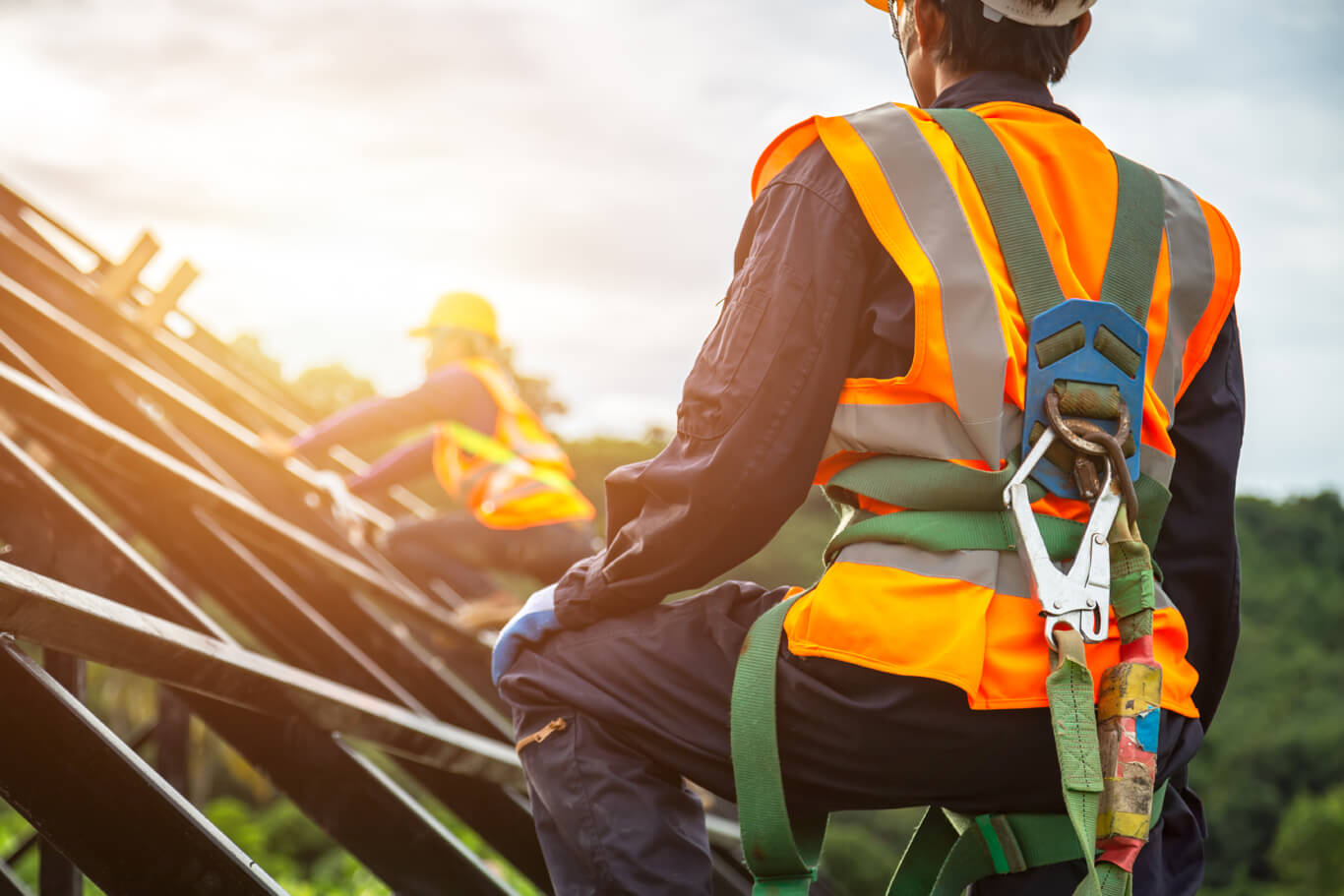 workers wear fall arrest systems per scaffolding safety guidelines