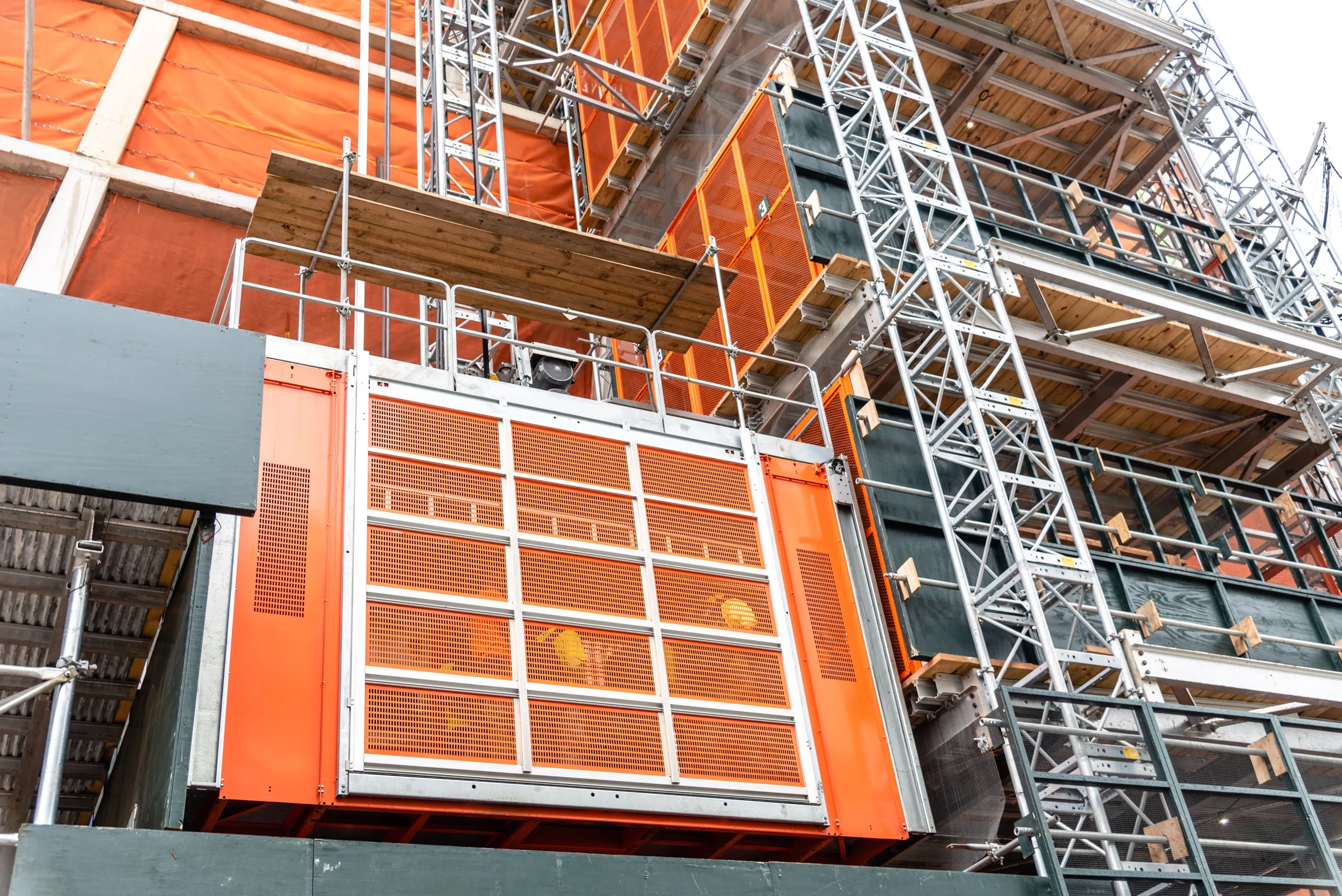 An industrial elevator with workers inside