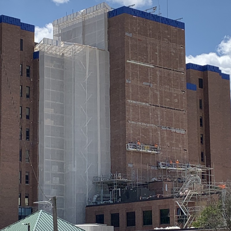 Scaffolding Solutions swing stage scaffolding on a multi-story hospital for exterior construction work.