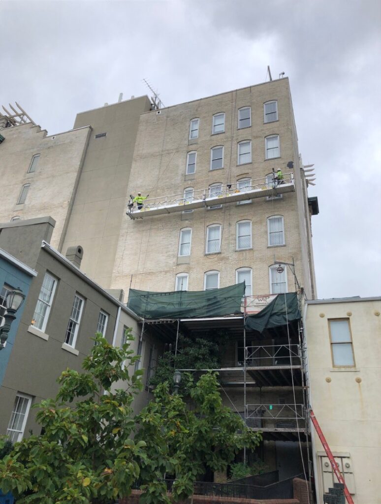 Scaffolding Solutions crew on suspended platform providing exterior building access and maintenance