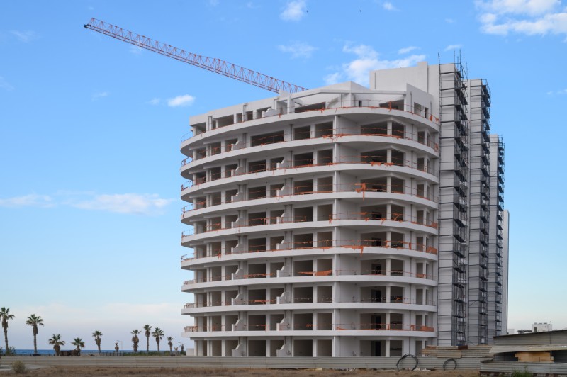 Scaffolding set up on the exterior of a multi-story building undergoing restoration and maintenance work.