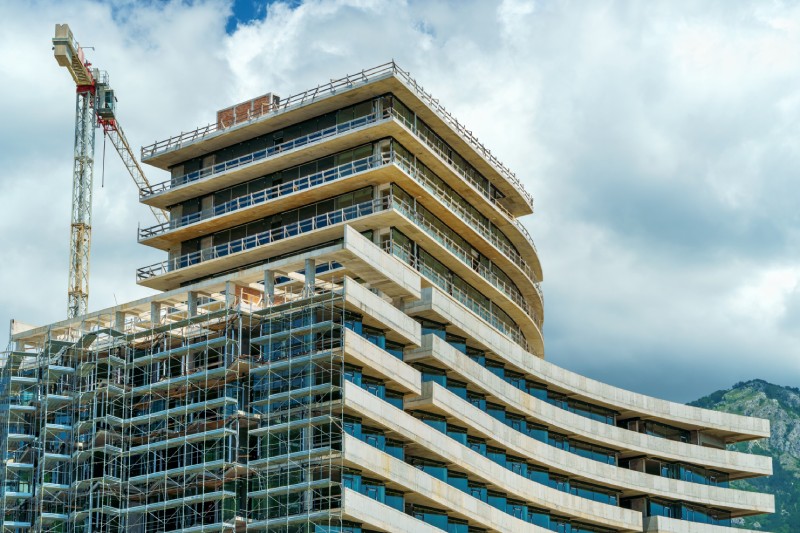 Scaffolding set up along the exterior of a modern high-rise building undergoing maintenance.